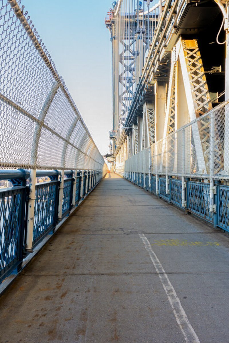 Empty Manhattan Bridge Walkway in New York City. Suspension bridge that connects Manhattan with Brooklyn with walking path, subway tracks and car roads