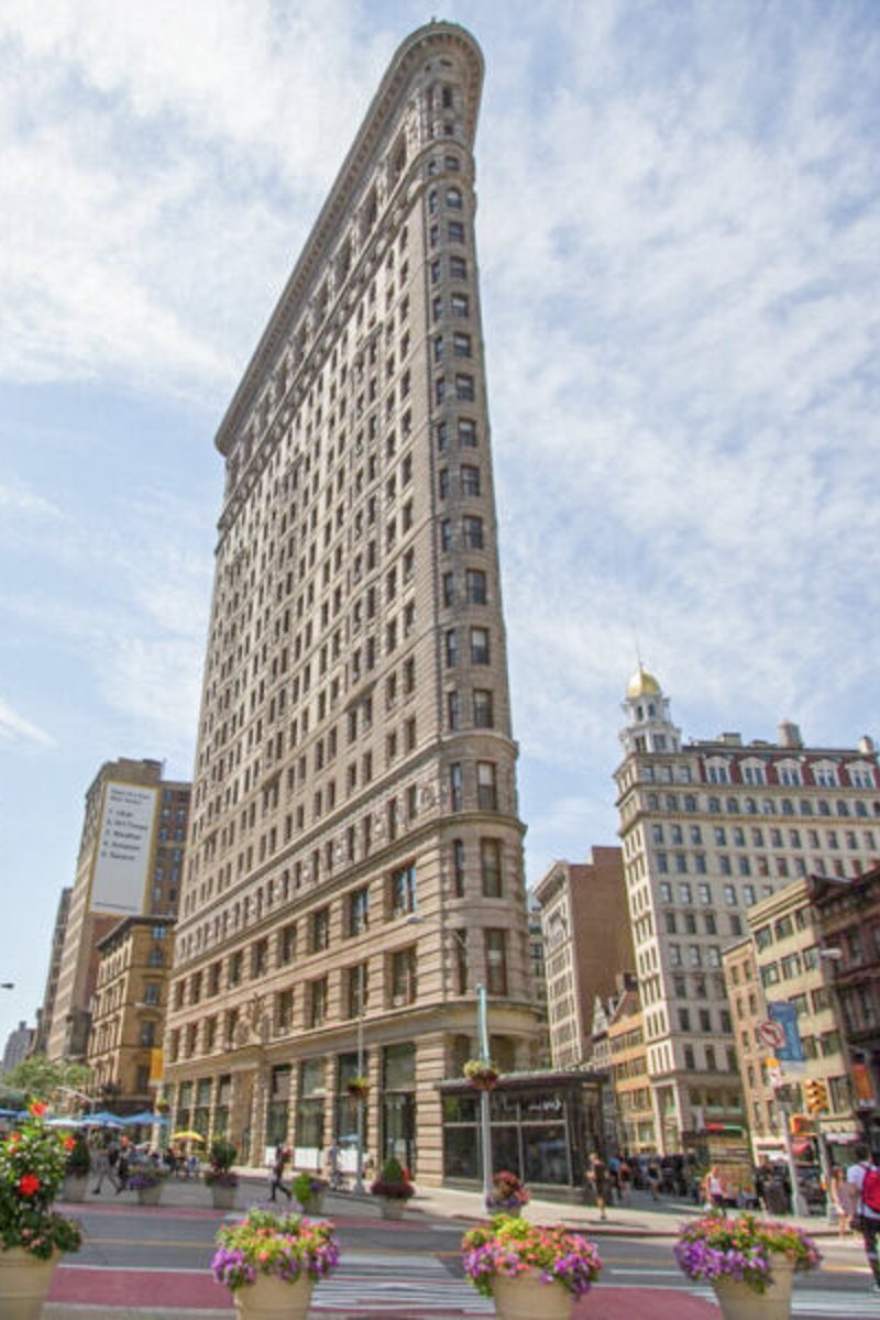 Flatiron building and buildings in Manhattan with blue sky