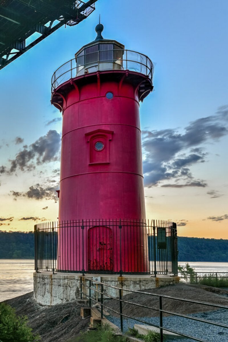 George Washington Bridge and the Red Little Lighthouse in Fort Washington Park, New York, NY in the evening.