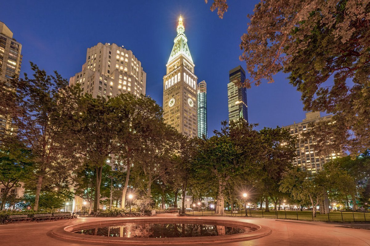 Madison Square Park in summer at twilight. Midtown skyscrapers, Manhattan, New York City