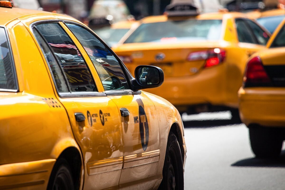 Yellow cab speeds through Times Square in New York, NY, USA.